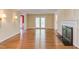 Spacious living room with hardwood floors, fireplace and double doors to the outside at 117 Carolina Forest Rd, Chapel Hill, NC 27516