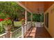 Inviting front porch with brick flooring, white railings, and decorative flower pots offering scenic views at 117 Carolina Forest Rd, Chapel Hill, NC 27516