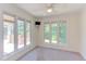 Sunlit room with large windows offering scenic views and deck access at 117 Carolina Forest Rd, Chapel Hill, NC 27516
