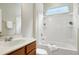 Bright bathroom featuring a bathtub/shower and vanity with storage at 118 Rosedale Creek Dr, Durham, NC 27703
