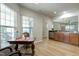 Sunny dining area with large windows and an antique table set; it is located adjacent to the kitchen at 118 Rosedale Creek Dr, Durham, NC 27703