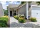 Charming home featuring a covered entryway, well-manicured landscaping and an attached one car garage at 118 Rosedale Creek Dr, Durham, NC 27703