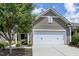 Charming home featuring a covered entryway, well-manicured landscaping and an attached one car garage at 118 Rosedale Creek Dr, Durham, NC 27703