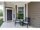 Inviting covered front porch with cozy seating and lovely landscaping, perfect for relaxing and enjoying the outdoors at 118 Rosedale Creek Dr, Durham, NC 27703