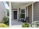 Inviting covered front porch with cozy seating and lovely landscaping, perfect for relaxing and enjoying the outdoors at 118 Rosedale Creek Dr, Durham, NC 27703