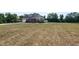 Scenic backyard view featuring lush greenery and a well-maintained brick residence at 120 Gentle Rain Dr, Garner, NC 27529