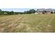Lush backyard featuring a well-manicured lawn and a classic brick home at 120 Gentle Rain Dr, Garner, NC 27529