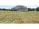 Expansive green backyard with a charming brick home and inviting white deck at 120 Gentle Rain Dr, Garner, NC 27529