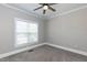 Bedroom with neutral color scheme, plush carpet, and window with bright sunlight at 120 Gentle Rain Dr, Garner, NC 27529