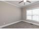 Neutral bedroom offers a ceiling fan, window with blinds, and plush carpet flooring at 120 Gentle Rain Dr, Garner, NC 27529