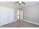 Bedroom featuring plush carpet, ceiling fan, closet, and passage to the rest of the house at 120 Gentle Rain Dr, Garner, NC 27529
