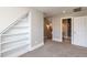 Bright bedroom features neutral walls, carpet, and built-in shelving for ample storage and organization at 120 Gentle Rain Dr, Garner, NC 27529