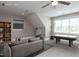Bonus room shows air hockey table, sofa, television, shelves and storage space at 120 Gentle Rain Dr, Garner, NC 27529