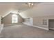 Spacious bonus room has a vaulted ceiling, carpet, natural light, and built-in storage options at 120 Gentle Rain Dr, Garner, NC 27529