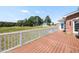 Lovely wooden deck overlooking a sprawling yard with lush trees and a clear blue sky at 120 Gentle Rain Dr, Garner, NC 27529