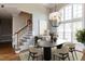 Dining room featuring an unique modern chandelier, neutral tones, and lots of natural light at 120 Gentle Rain Dr, Garner, NC 27529