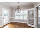 Bright dining area features hardwood floors, a modern chandelier, and lots of natural light from large windows at 120 Gentle Rain Dr, Garner, NC 27529
