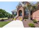 Inviting front entrance with well-maintained landscaping and a charming arched entryway at 120 Gentle Rain Dr, Garner, NC 27529