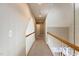 Well-lit hallway with neutral walls, carpeted floor, and white railing for a welcoming and bright atmosphere at 120 Gentle Rain Dr, Garner, NC 27529