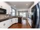 Modern kitchen featuring white cabinets, granite countertops, and stainless steel appliances at 120 Gentle Rain Dr, Garner, NC 27529