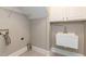 Laundry room features tiled floor, sink, upper cabinets, and hook ups for laundry machines at 120 Gentle Rain Dr, Garner, NC 27529
