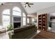 Staged living room showcasing a fireplace, large windows, modern furniture, and an open layout at 120 Gentle Rain Dr, Garner, NC 27529