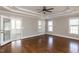 Large main bedroom with tray ceiling, hardwood floors, an open sunroom, and plenty of natural light at 120 Gentle Rain Dr, Garner, NC 27529