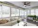Comfortable sunroom showing ample windows, tiled floor, and comfortable furniture at 120 Gentle Rain Dr, Garner, NC 27529