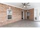 Sunroom features brick walls, tile flooring, ceiling fan, and ample windows for natural lighting at 120 Gentle Rain Dr, Garner, NC 27529