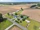 Expansive aerial view showcases a rural property with multiple structures, open fields, and a serene, private setting at 12294 Nc Hwy 96 S, Dunn, NC 28334