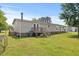 Inviting backyard with a wooden deck, perfect for outdoor entertaining and relaxing in the sun at 12294 Nc Hwy 96 S, Dunn, NC 28334