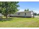 Spacious backyard featuring a lush green lawn and mature trees creating a serene outdoor space at 12294 Nc Hwy 96 S, Dunn, NC 28334
