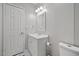 Bright bathroom features a modern sink and vanity, white walls, and a tiled floor at 12294 Nc Hwy 96 S, Dunn, NC 28334