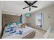 Bedroom features a ceiling fan, decorative butterfly pillows and bedspread, and natural light at 12294 Nc Hwy 96 S, Dunn, NC 28334