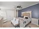 Bedroom with a ceiling fan, neutral-colored carpet, and a navy blue accent wall at 12294 Nc Hwy 96 S, Dunn, NC 28334