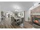 Bright dining area featuring a stone fireplace, stylish gray chairs, and an open floor plan to the kitchen at 12294 Nc Hwy 96 S, Dunn, NC 28334