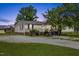 Inviting single-story home features a well-maintained yard, a gravel driveway, and a charming front porch with brick accents at 12294 Nc Hwy 96 S, Dunn, NC 28334