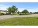 Expansive front yard with a well-kept lawn and a gravel driveway, offering ample parking space at 12294 Nc Hwy 96 S, Dunn, NC 28334