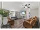 Spacious living room with hardwood floors, comfortable sofas, and a mounted TV at 12294 Nc Hwy 96 S, Dunn, NC 28334