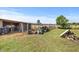 Rustic shed with fenced area in a grassy yard, great for storage or animal shelter at 12294 Nc Hwy 96 S, Dunn, NC 28334