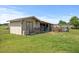 Practical shed in a grassy yard, perfect for storage or a hobby workspace at 12294 Nc Hwy 96 S, Dunn, NC 28334