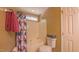 This bathroom features a white tub with shower, white toilet and neutral walls at 133 Parkhaven Ln, Garner, NC 27529