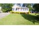 Inviting single Gathering home with green lawn, neat landscaping, and paved driveway at 133 Parkhaven Ln, Garner, NC 27529