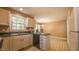 View of eat-in kitchen features white cabinets, black appliances, and tiled floor at 133 Parkhaven Ln, Garner, NC 27529