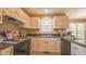 Bright kitchen features neutral cabinetry, laminate countertops, and tiled floors at 133 Parkhaven Ln, Garner, NC 27529