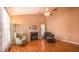 Comfortable living room with hardwood floors, fireplace, ceiling fan and neutral color palette at 133 Parkhaven Ln, Garner, NC 27529