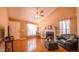 Bright living room featuring hardwood floors, fireplace, ceiling fan and ample natural light at 133 Parkhaven Ln, Garner, NC 27529