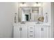 Bright bathroom featuring double sinks, a large mirror, and white cabinetry providing a fresh and functional space at 1602 Bowery Dr, Raleigh, NC 27607