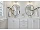 Elegant bathroom featuring double sinks, white cabinets, and stylish wallpaper, creating a serene and functional space at 1602 Bowery Dr, Raleigh, NC 27607