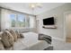 Bright bedroom with a cozy blanket, plush pillows, and large windows showcasing natural light and outdoor views at 1602 Bowery Dr, Raleigh, NC 27607